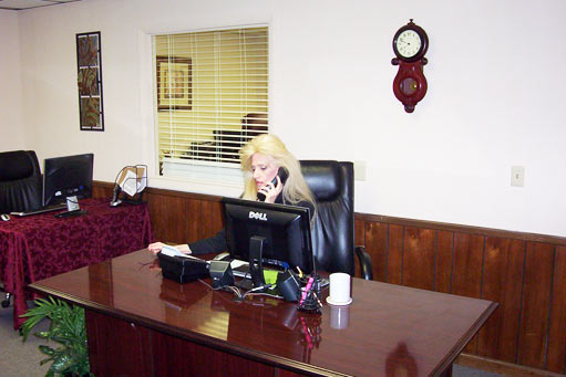 Treva seated at the glossy rectangular desk in our former Murfreesboro office